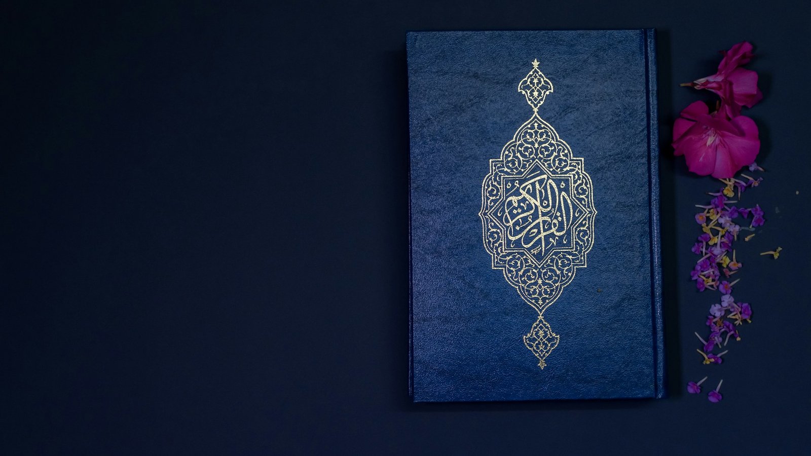 Ornate Quran on a calm dark background