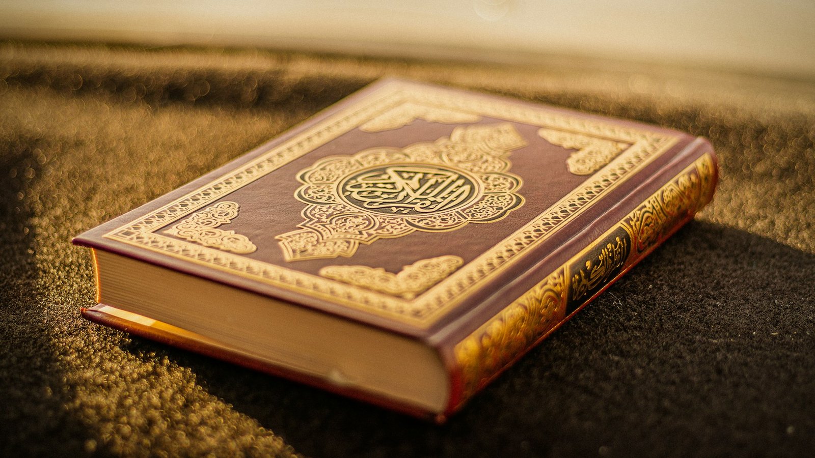 Gold-embossed Quran in warm light