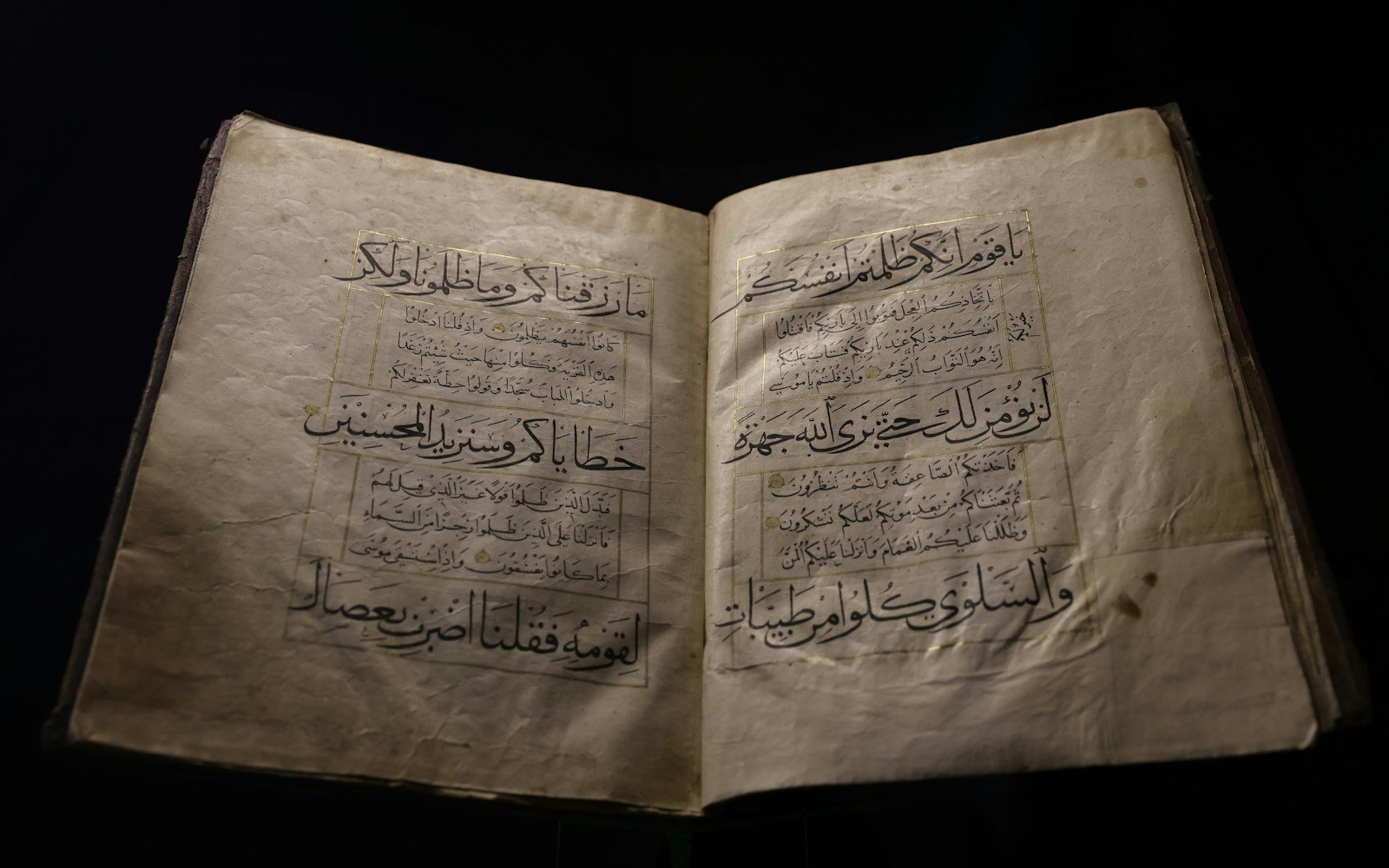 Open Quran with Arabic calligraphy on aged pages